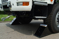 Wheel wedges to secure vehicles during winch operation
